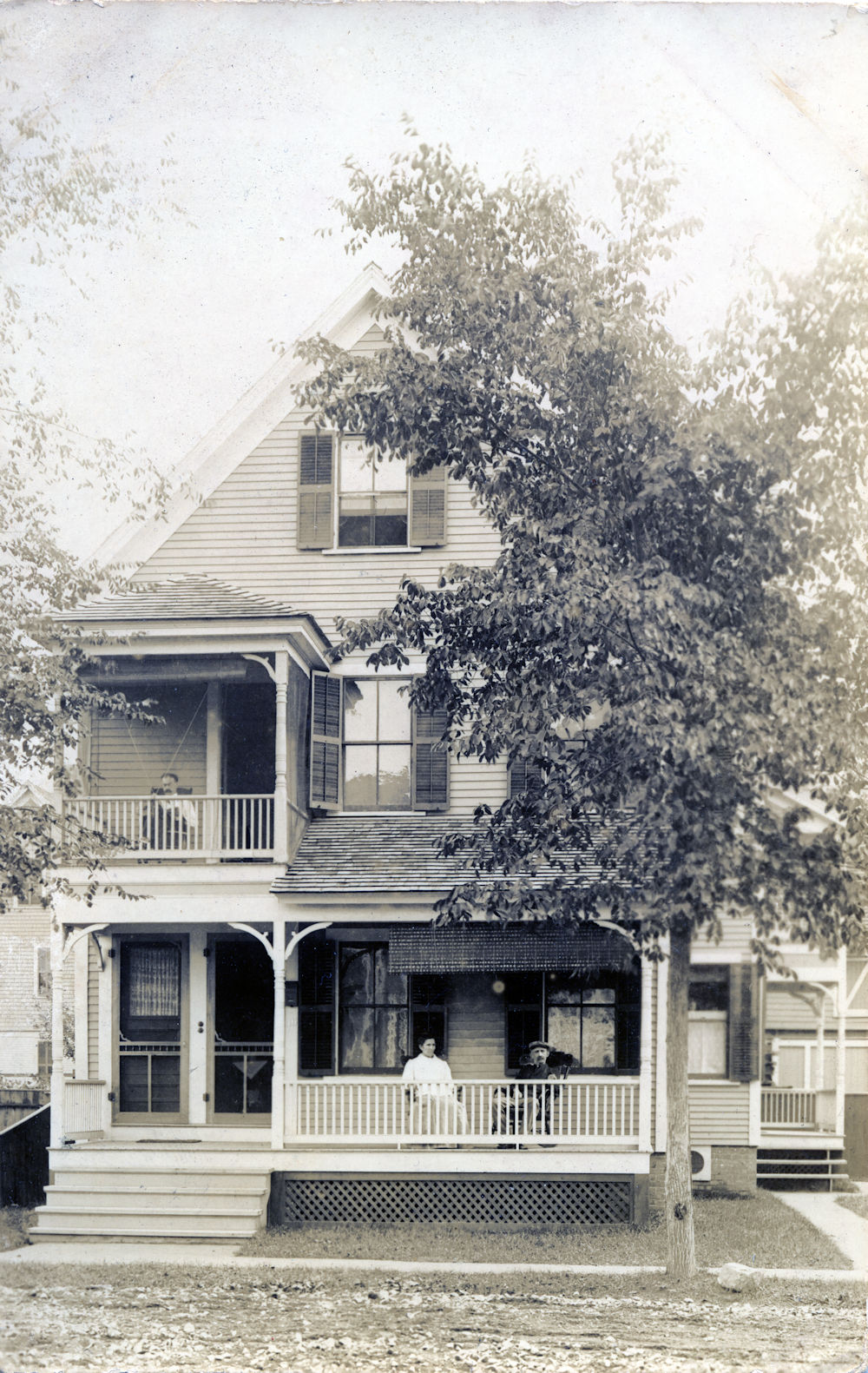 Unknown house with couple on front porch